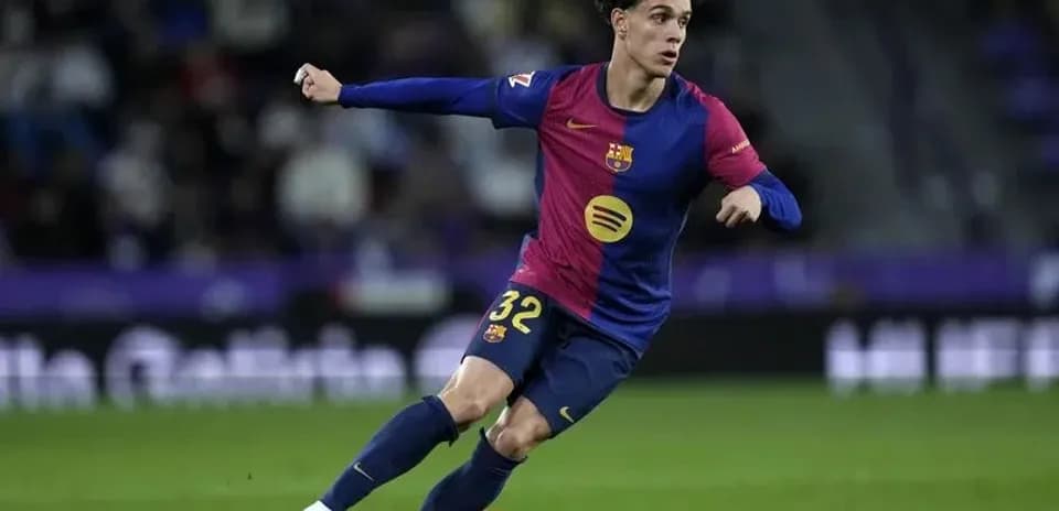 Barcelona player dribbling the ball on field