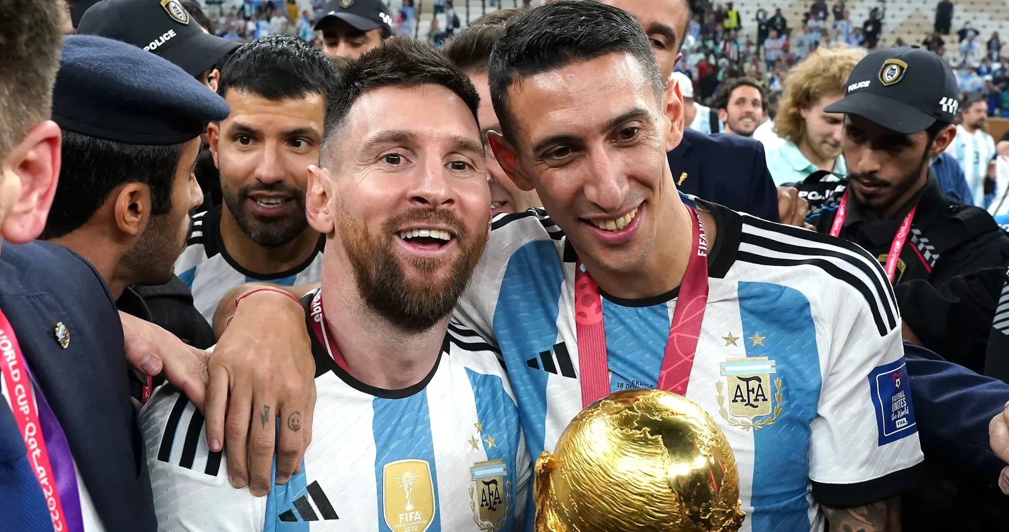 Messi and Di Maria celebrating with World Cup trophy