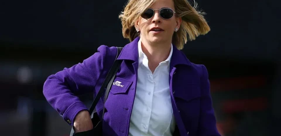 Woman in purple jacket walking with bag