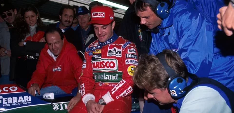 F1 driver with team members near racing car