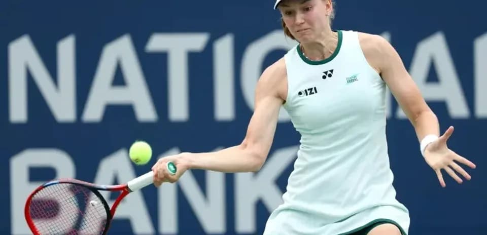 Tennis player hitting a backhand stroke during match
