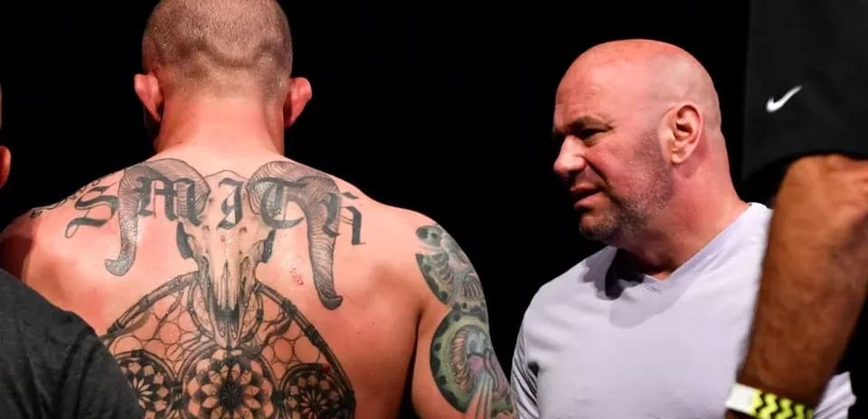Man with tattoos talking to another man