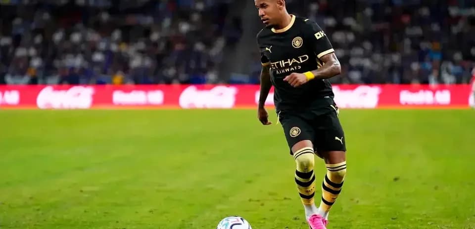 Futbolchi to'pni ushlamoqda, maydonda harakatda