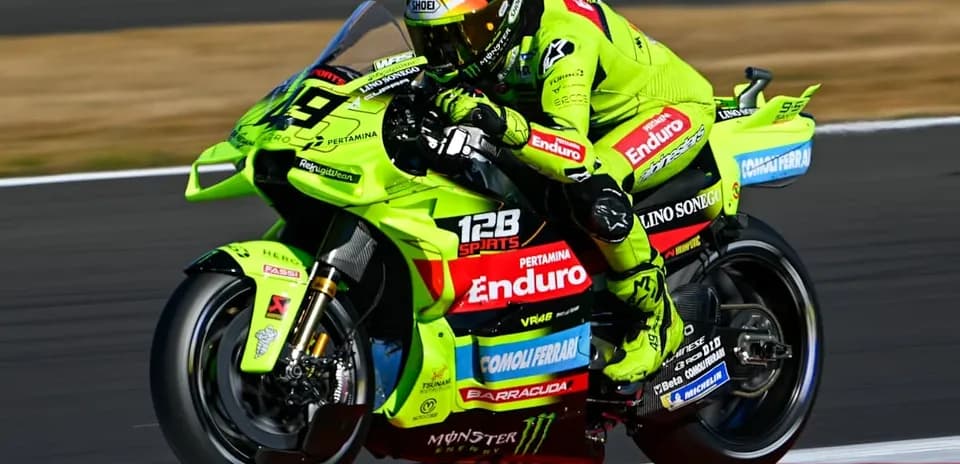 Motogp rider on a bright green motorcycle racing