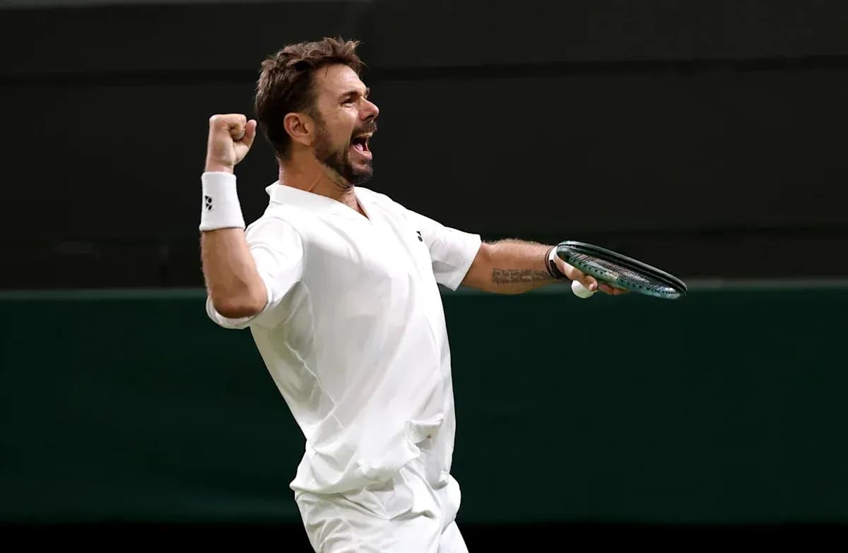 Tennis player celebrating with racket during match