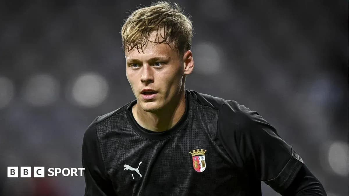 Goalkeeper in black uniform during match preparation