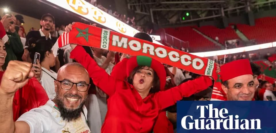 Fans celebrating with Morocco scarves in stadium