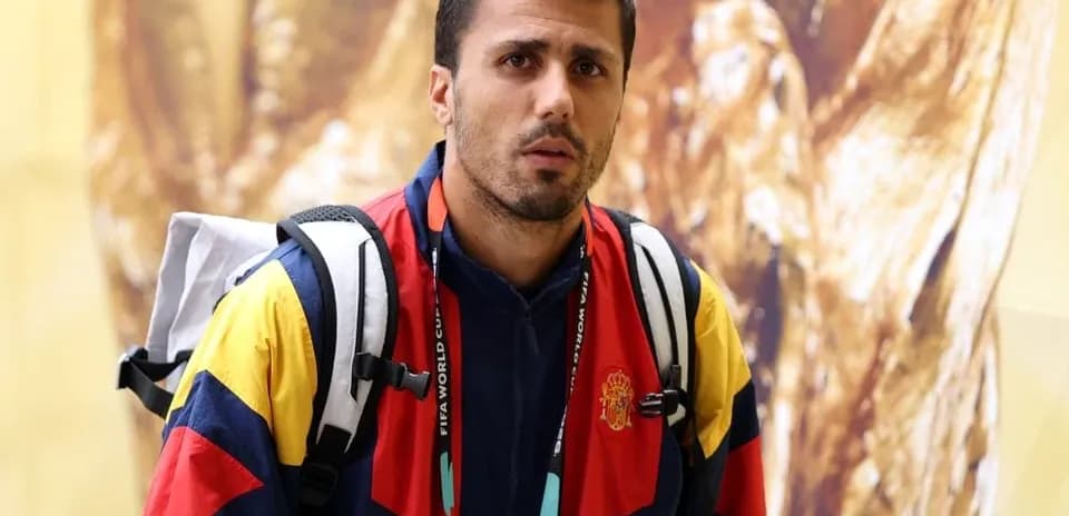 Athlete in team jacket with backpack indoors