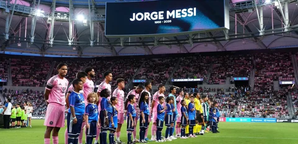 Players and children lining up before the match