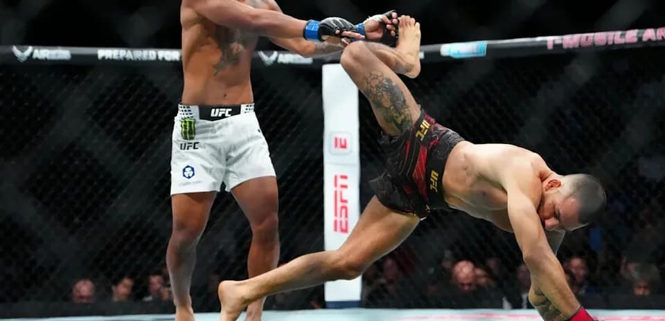 MMA fighters engaged in a grappling maneuver