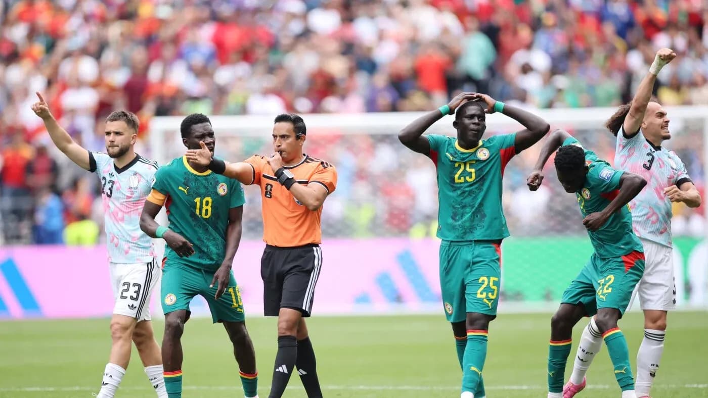 Senegal players reacting during a match with referee