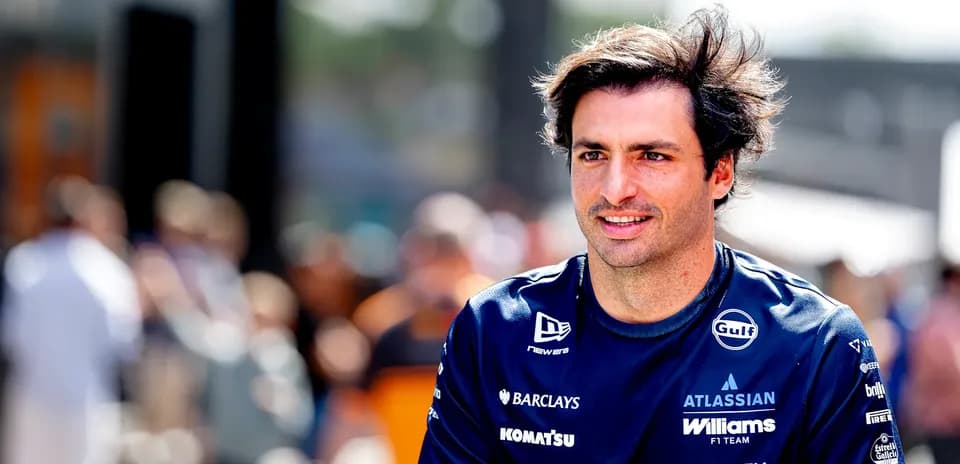 F1 driver in team uniform walking in paddock
