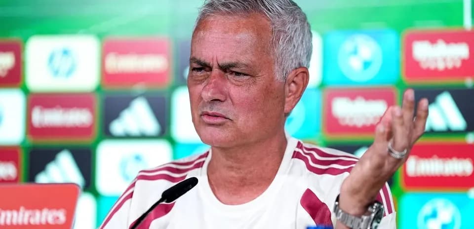 Murinho press conference with team branding in background