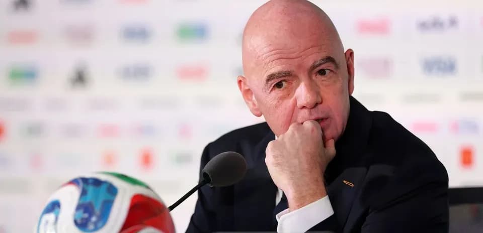 FIFA president at press conference with ball