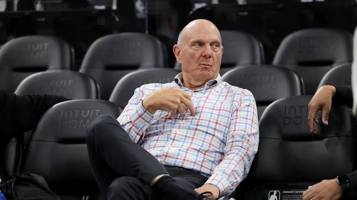 Man sitting on bench at basketball arena