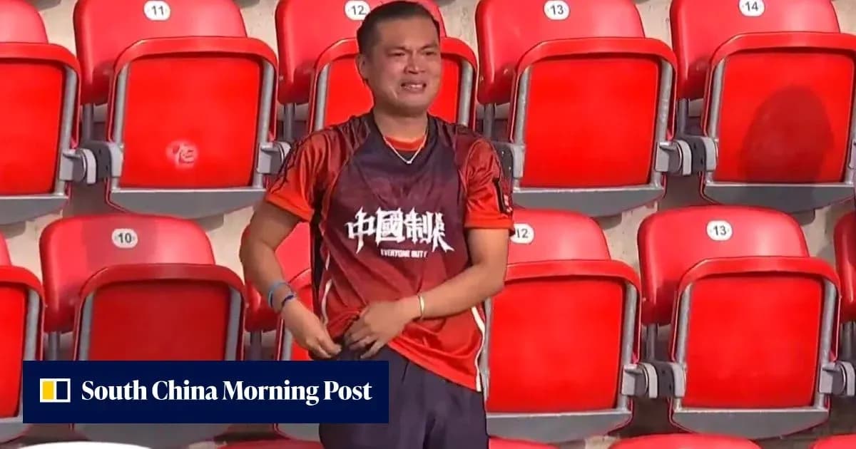 Fan wearing red jersey in empty stadium seats