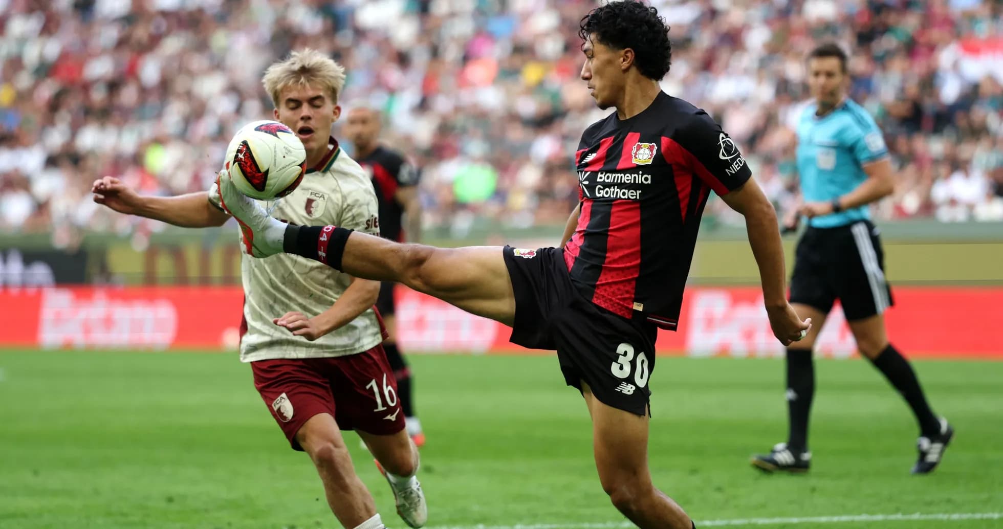 Bayer Leverkusen player kicking ball during match
