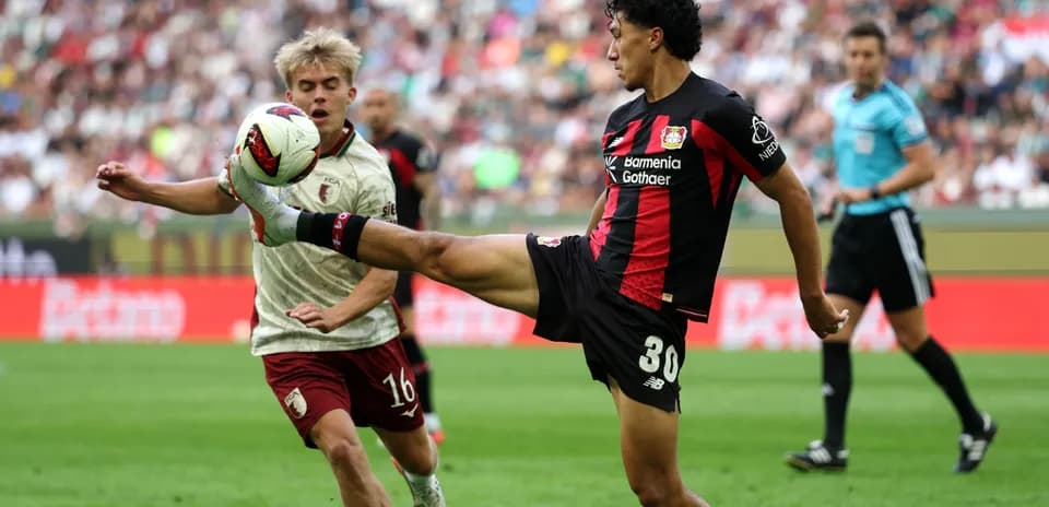 Bayer Leverkusen player kicking ball during match