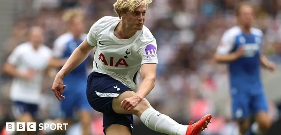 Tottenham player kicking the ball during match