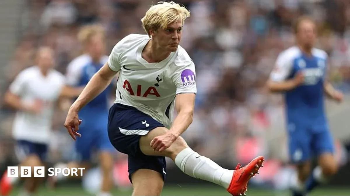 Tottenham player kicking the ball during match