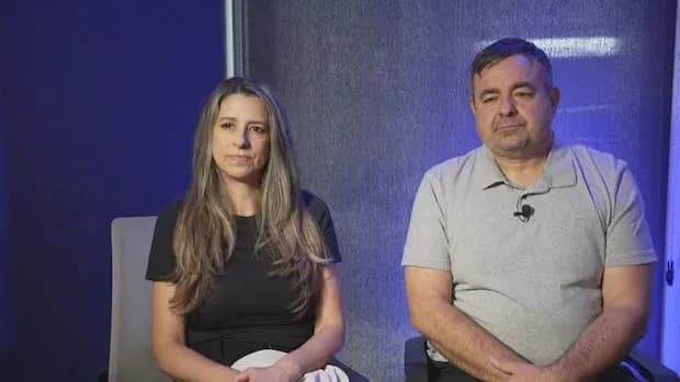 Two individuals sitting together in a studio