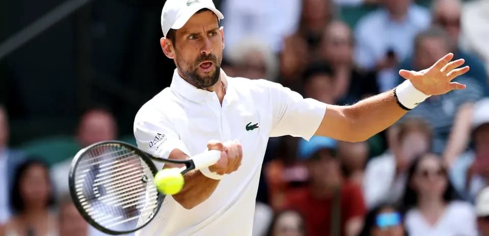 Tennis player hitting a backhand shot during match