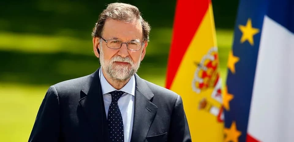 Politician standing with Spanish and French flags