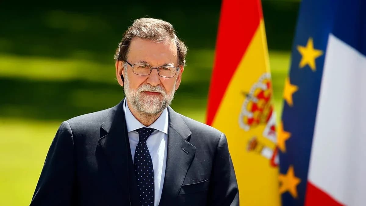 Politician standing with Spanish and French flags