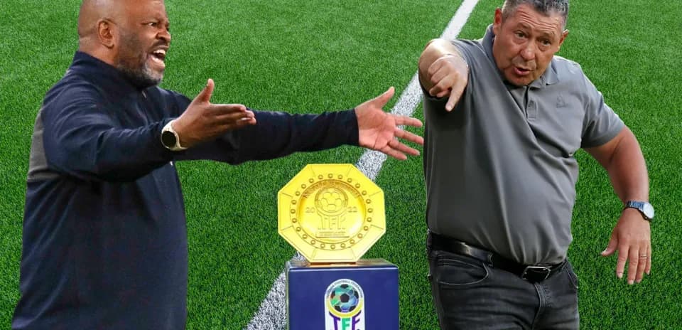 Two coaches arguing near trophy on field