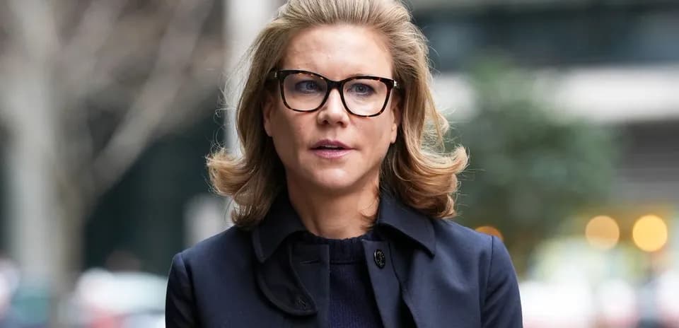 Woman wearing glasses walking outdoors in city