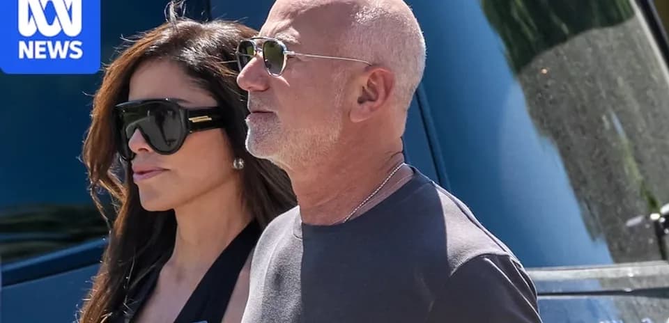 Two people walking together in sunglasses