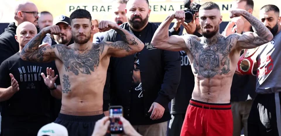 Boxers flexing muscles during weigh-in event