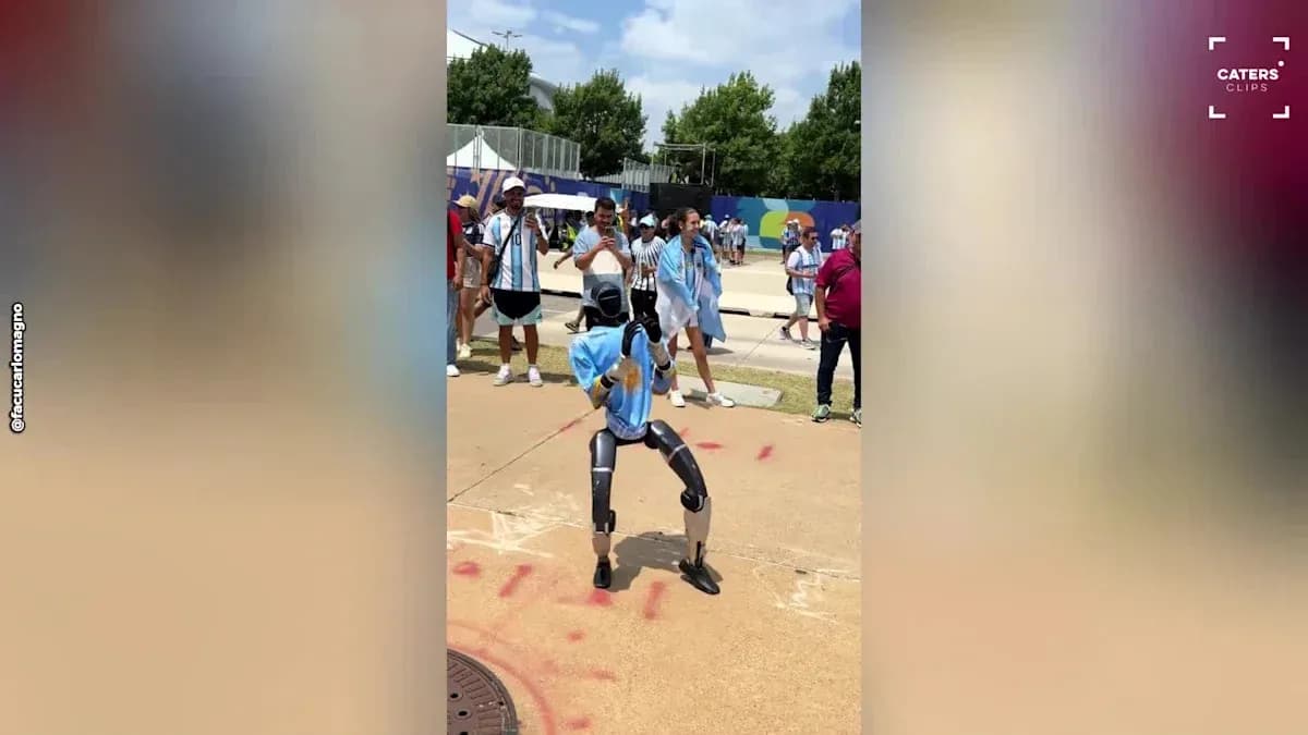 Robot dancing in front of cheering crowd