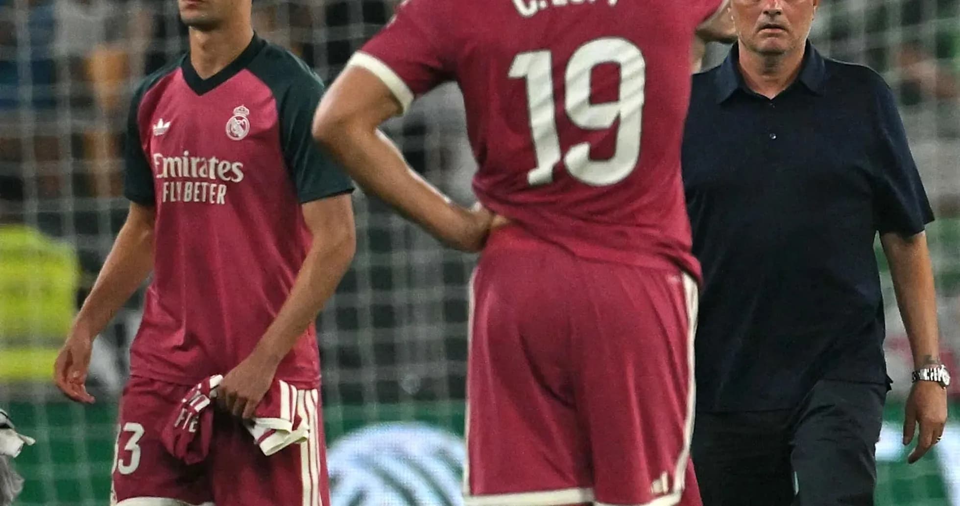 Real Madrid players and coach on the field after match