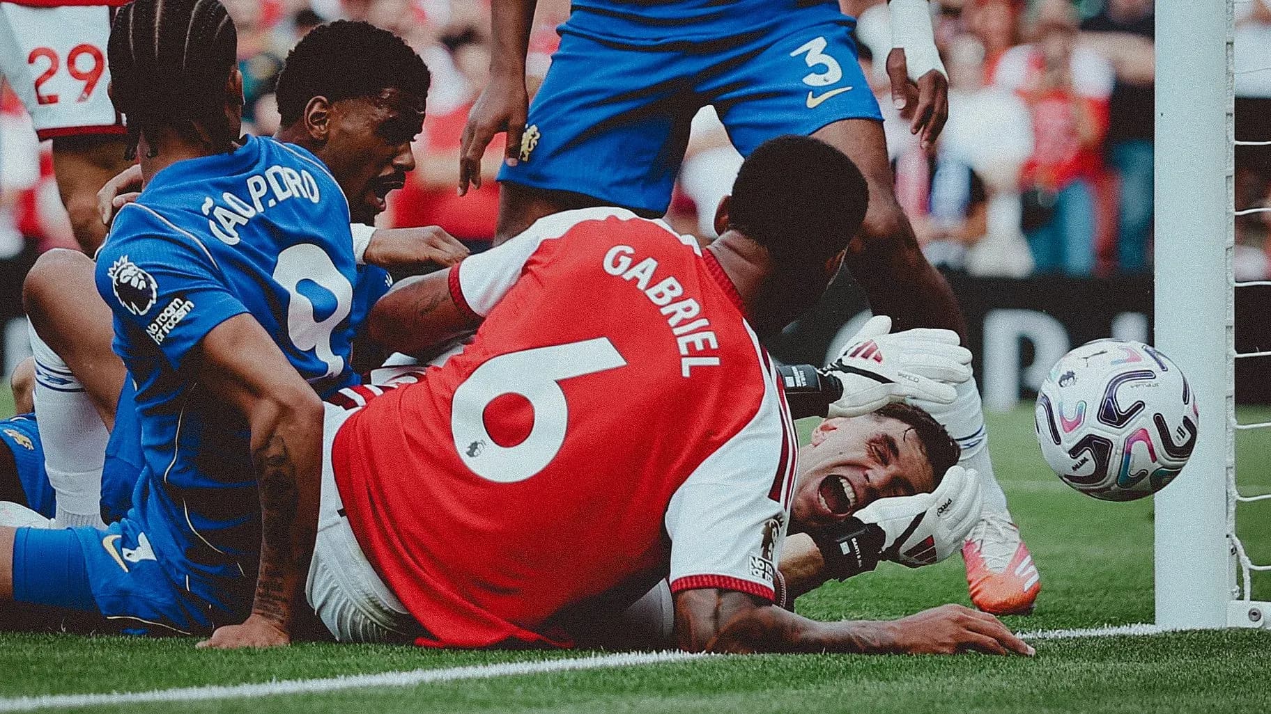 Players battling for the ball near the goal line