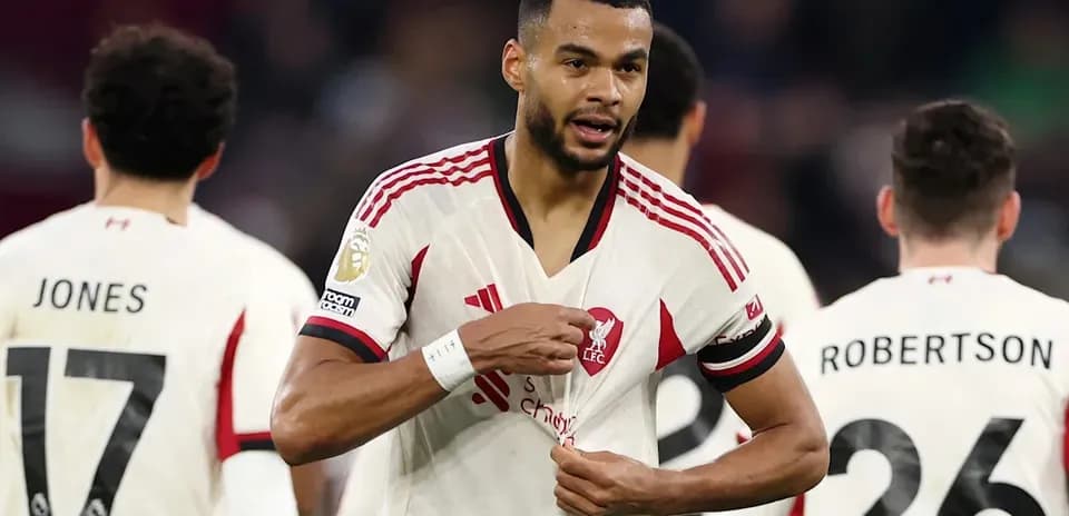 Liverpool player adjusting his jersey during match