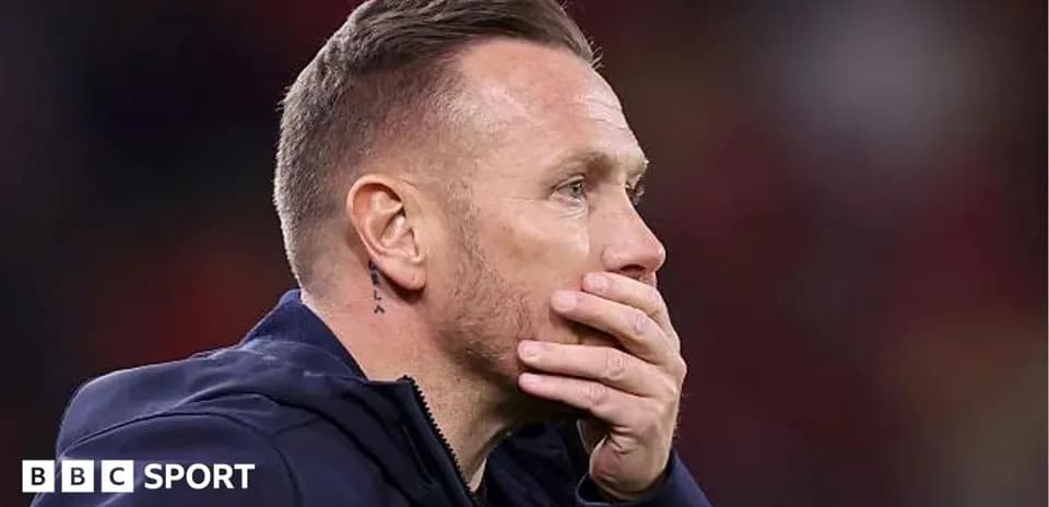 Coach with hand on face during match