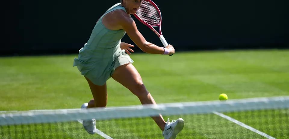 Tennis player hitting a ball during match
