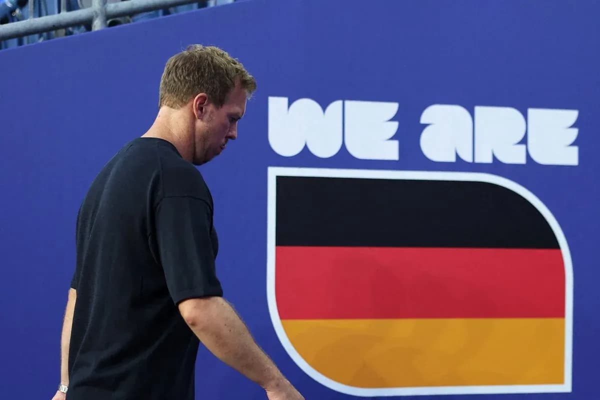 Athlete walking past 'We Are Germany' sign