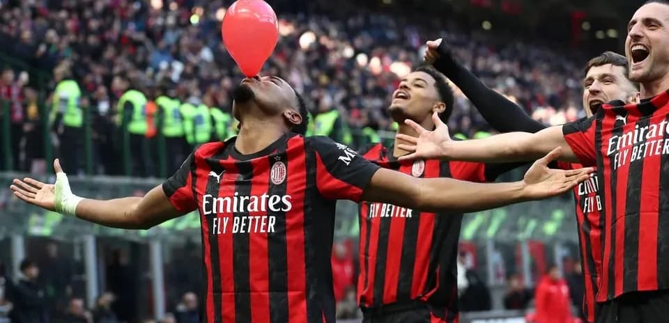 AC Milan players celebrating with balloon during match