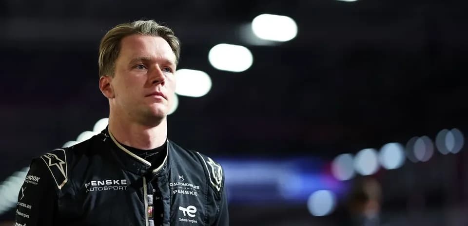 Driver in racing suit preparing for competition