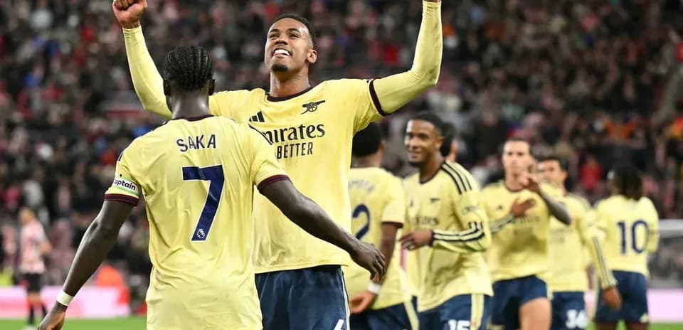 Arsenal players celebrating a goal on the pitch