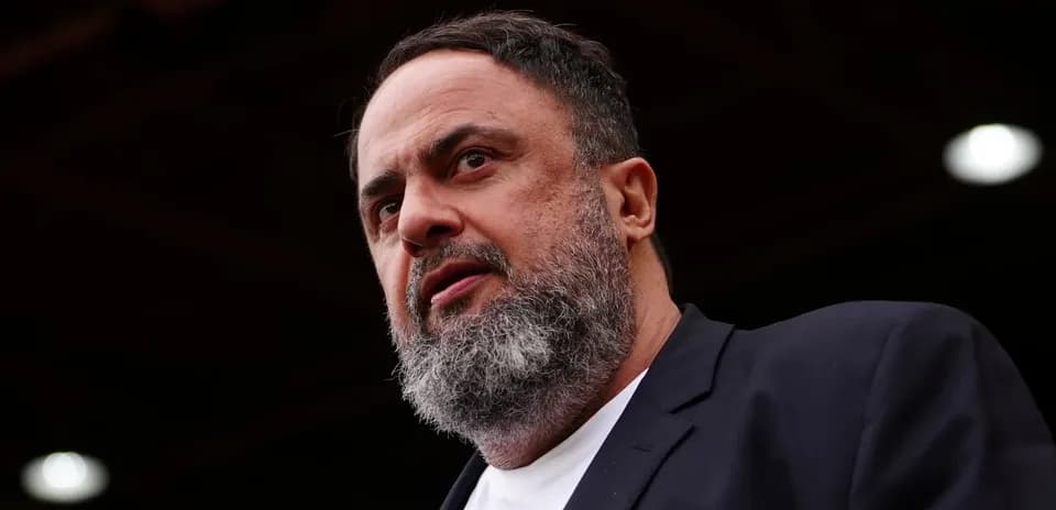 Man with beard speaking at event