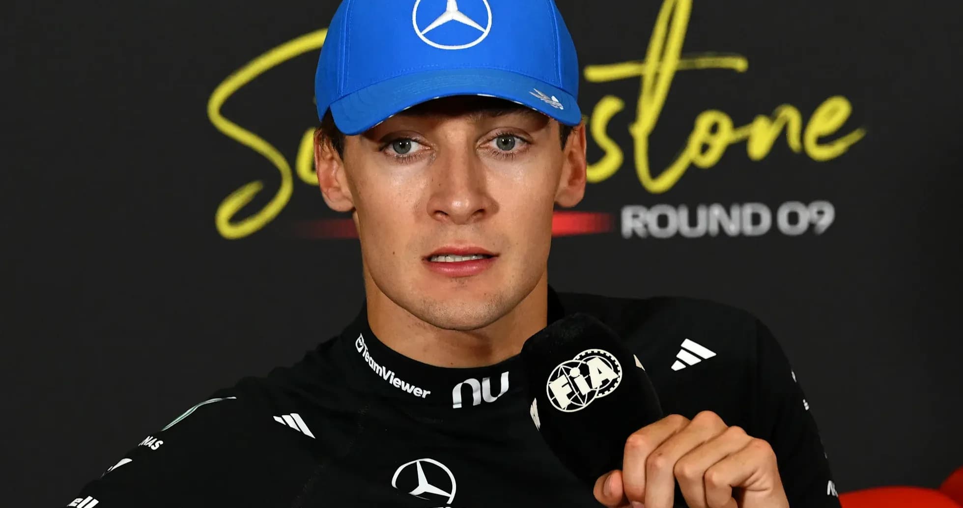 Formula 1 driver at press conference with microphone