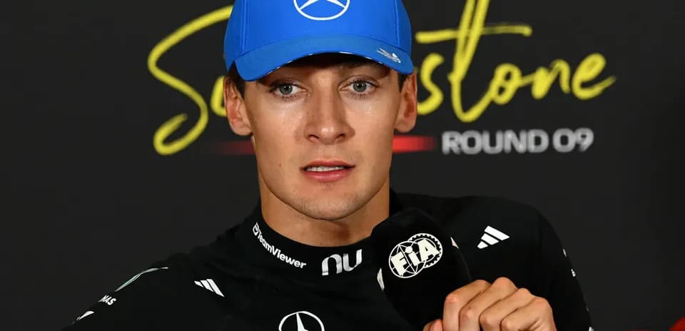 Formula 1 driver at press conference with microphone