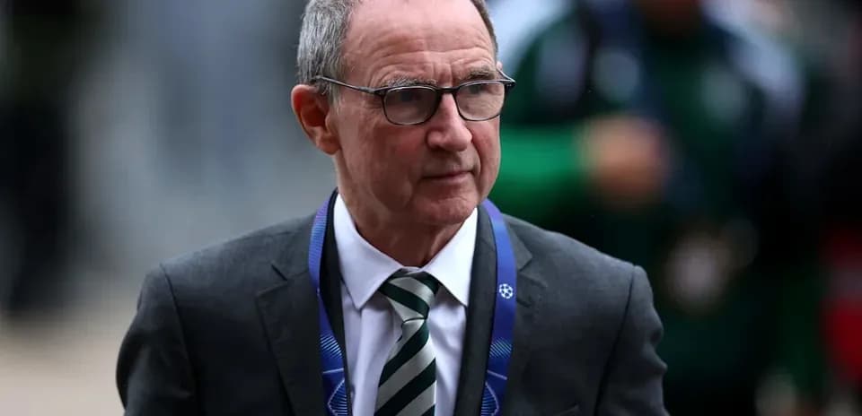 Person in suit walking with UEFA lanyard