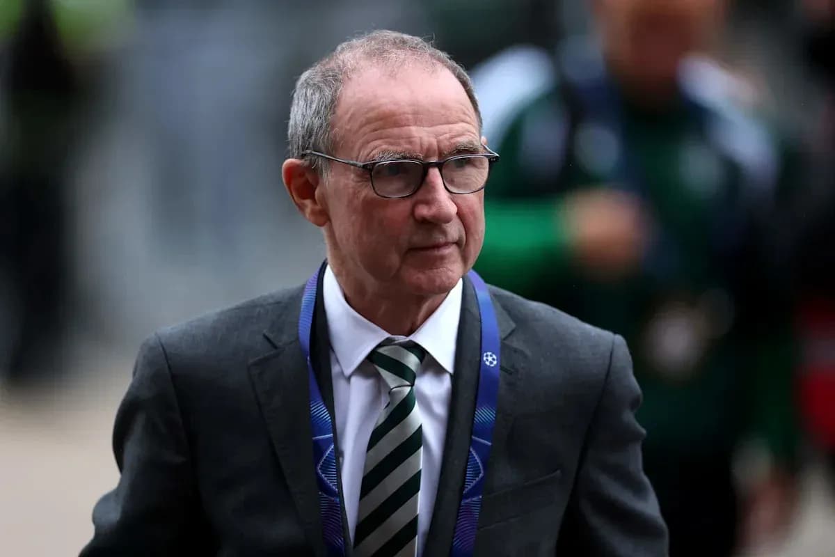 Person in suit walking with UEFA lanyard