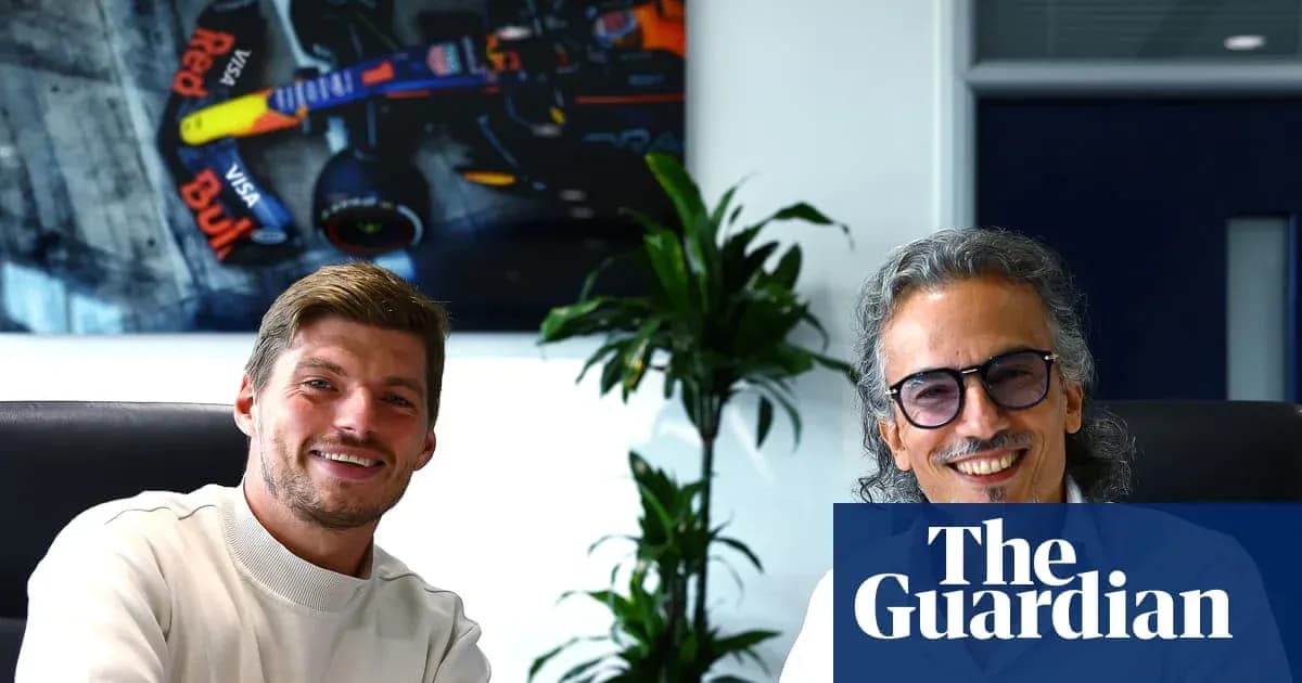 Two men smiling in an office with a car backdrop