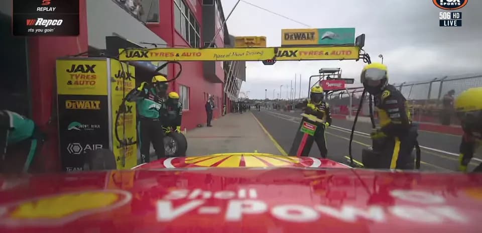 Pit crew servicing car during race pit stop