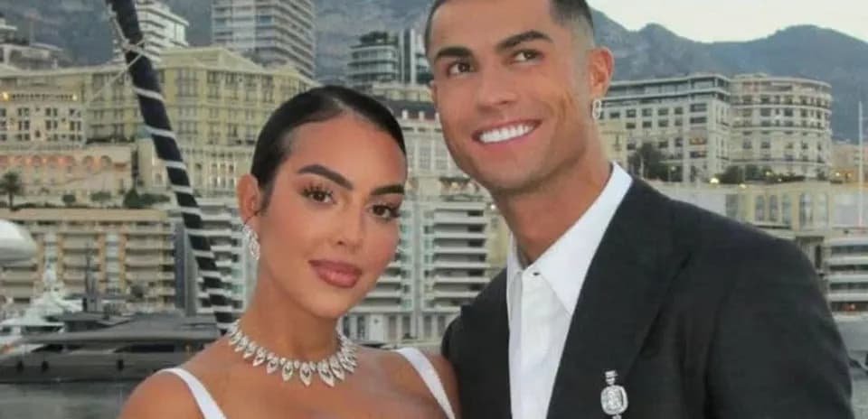 Couple posing with city skyline in background